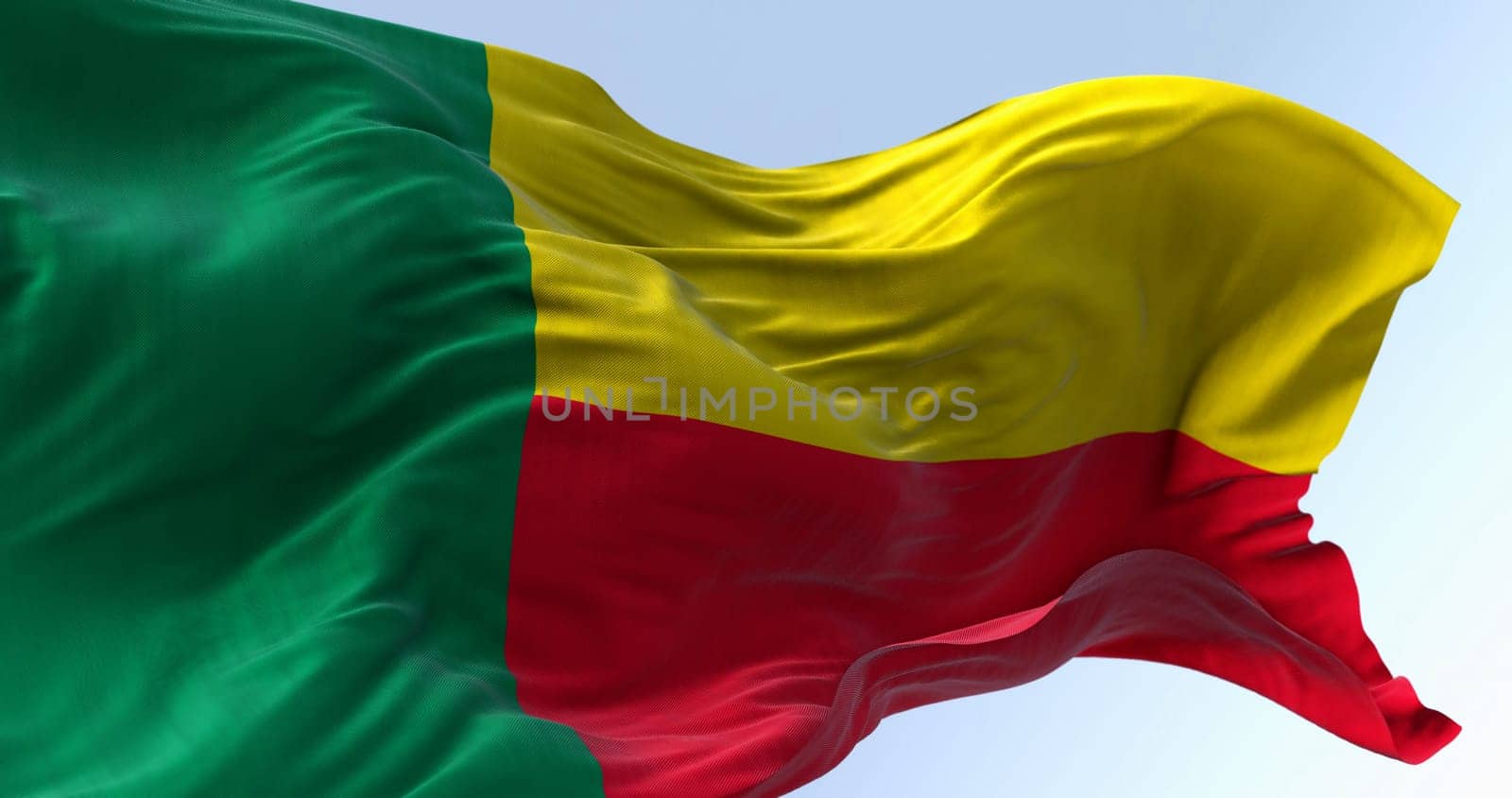 Close-up of Benin national flag waving. Two horizontal yellow and red bands on the fly side and a green vertical band at the hoist. 3d illustration render. Fluttering fabric. Selective focus