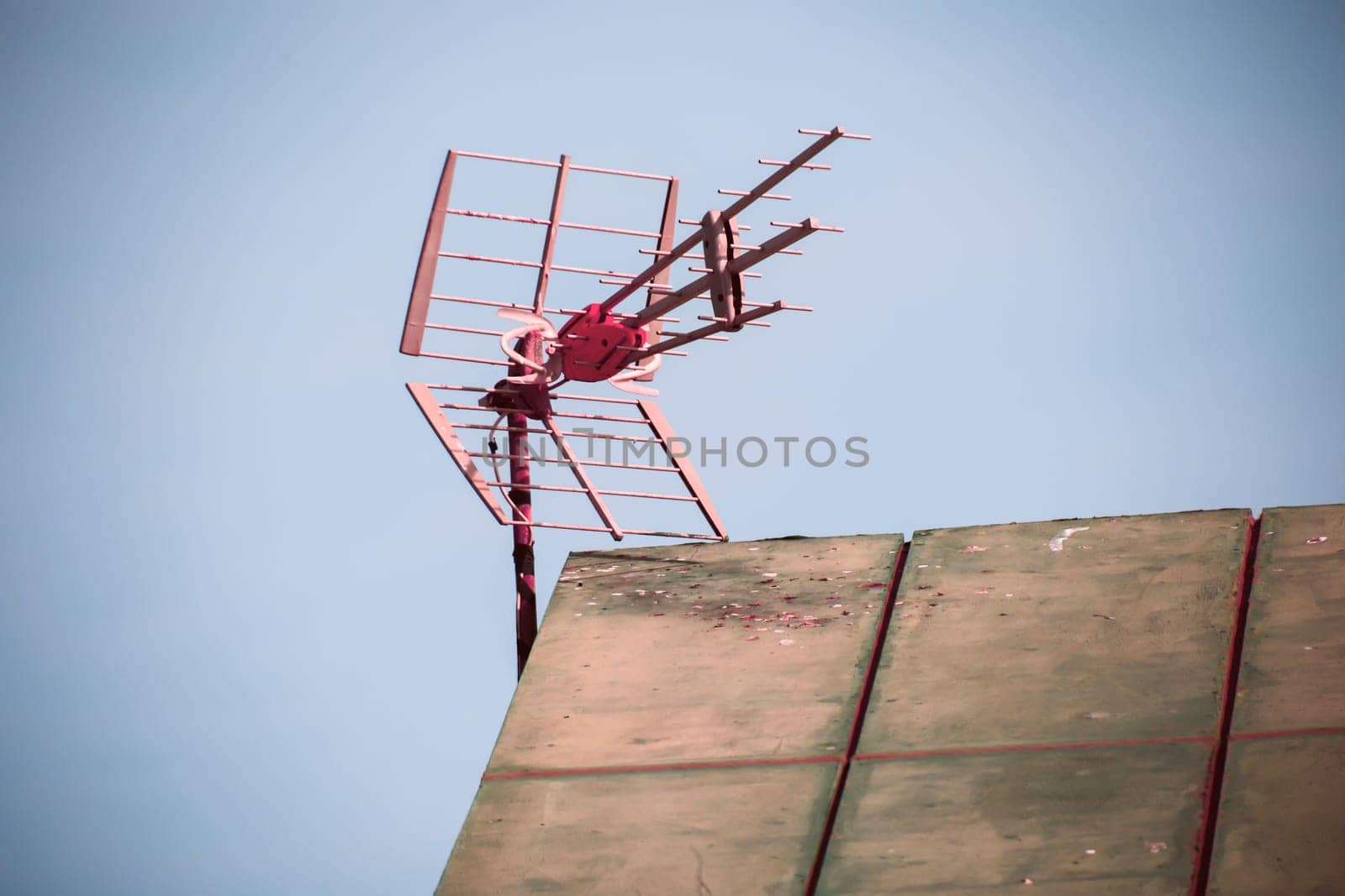 A VHF UHF antenna on a roof. An antenna for receiving a radio station, or TV programmes.