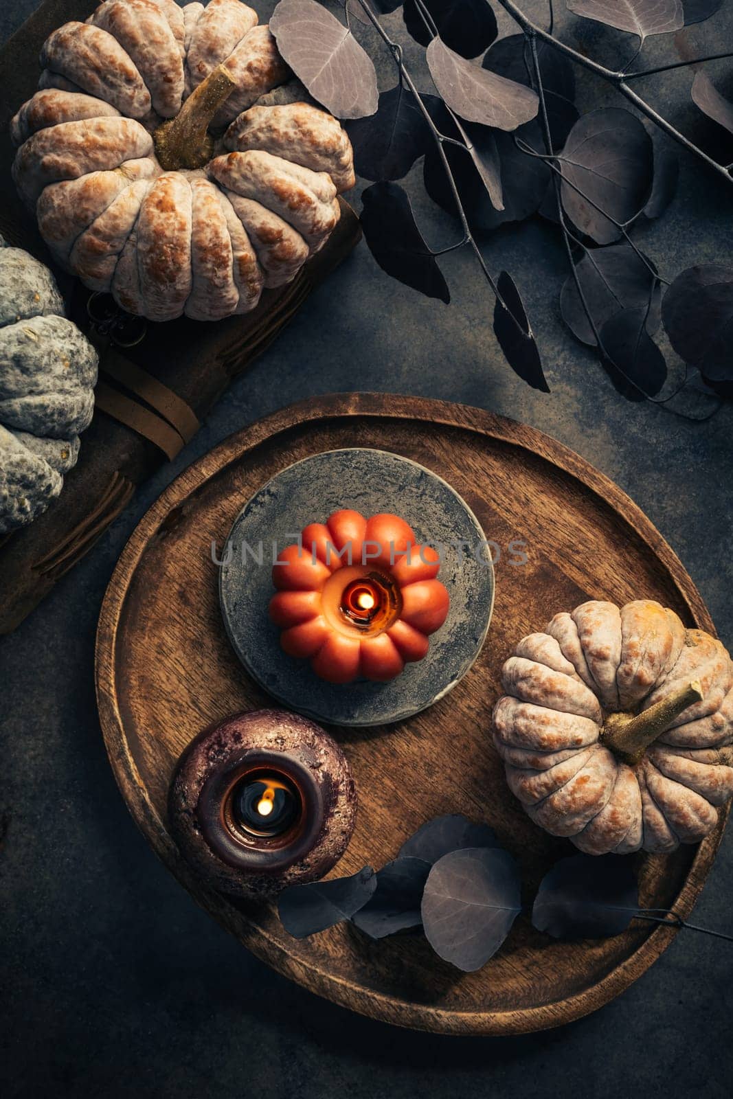 Fall candle decoration with  pumpkins, wooden home decor still life scented candle, autumn season interior decoration details