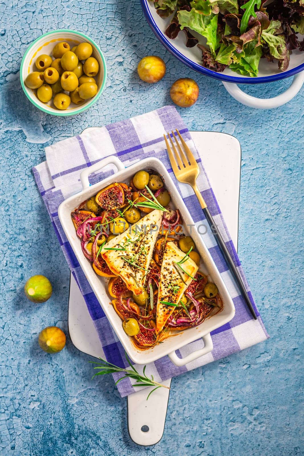 Baked sheep cheese, feta cheese with olives, figs, onions and green salad (Bouyiourdi)