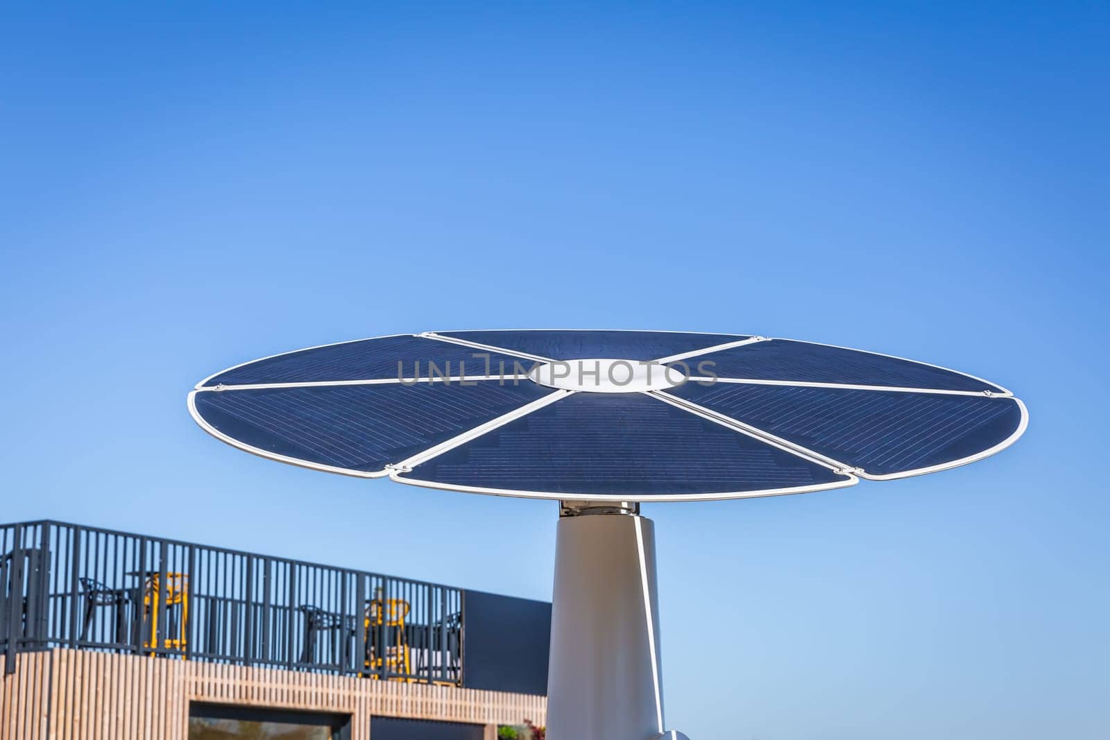 Rotating solar panel in flower shape in a city. Photovoltaic, alternative electricity source
