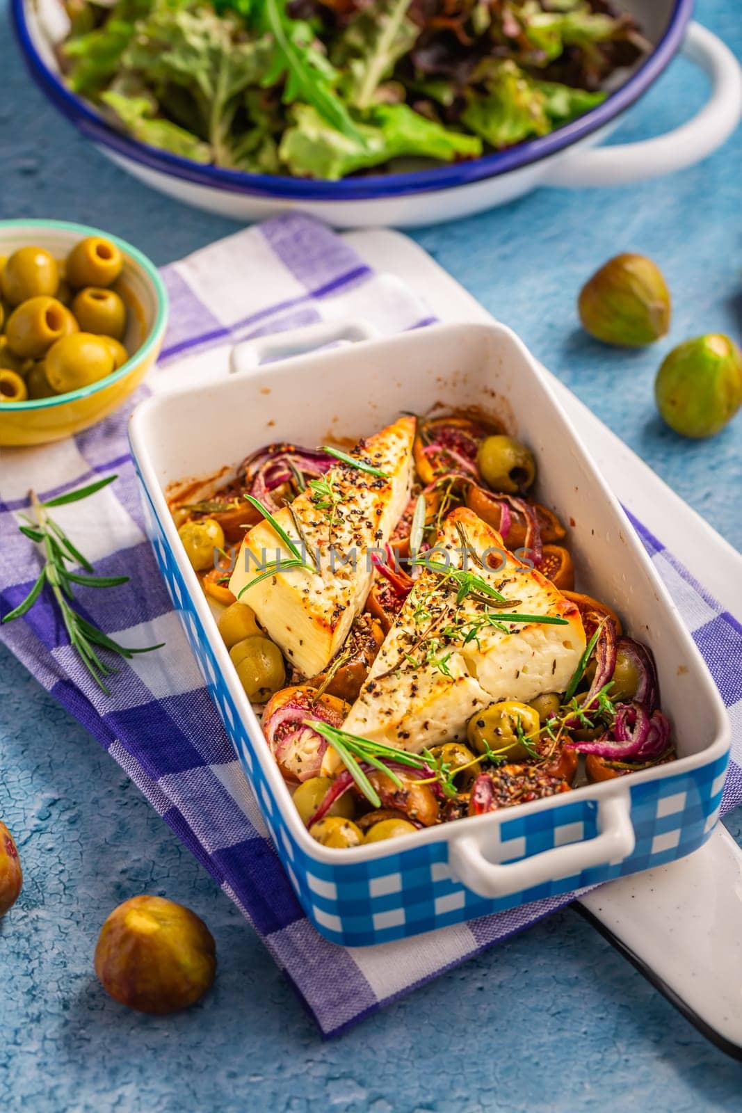Baked sheep cheese, feta cheese with olives, figs, onions and green salad (Bouyiourdi)