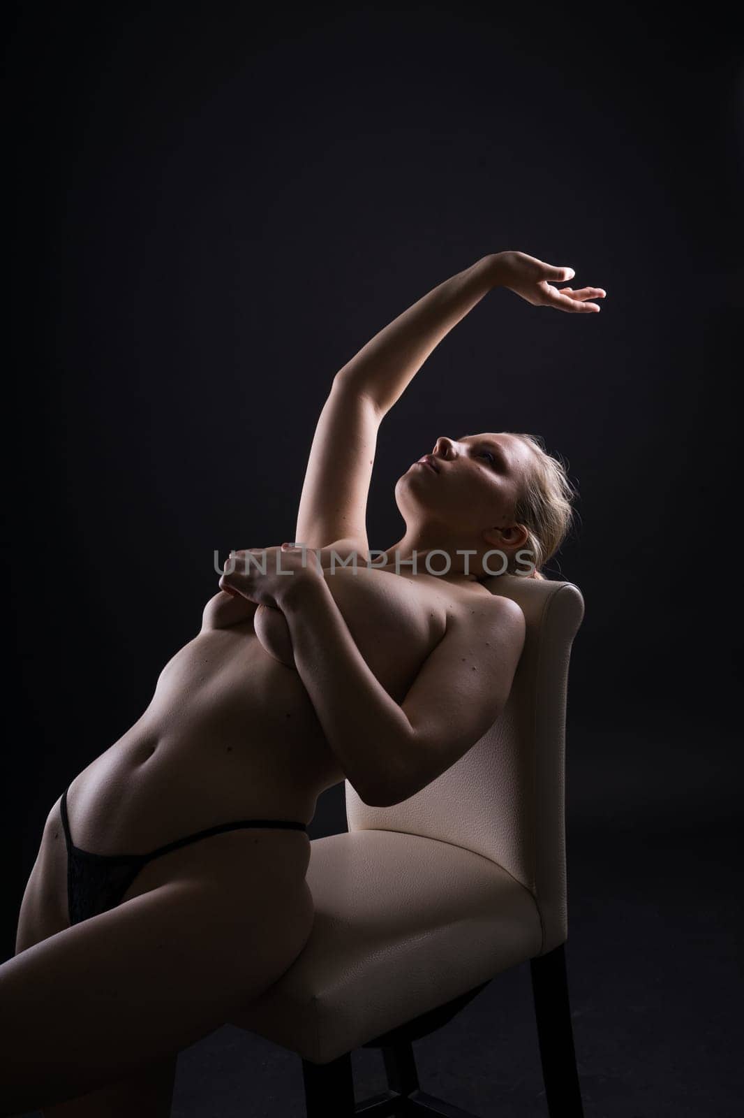 Happy plump body positive blond haired lady poses topless