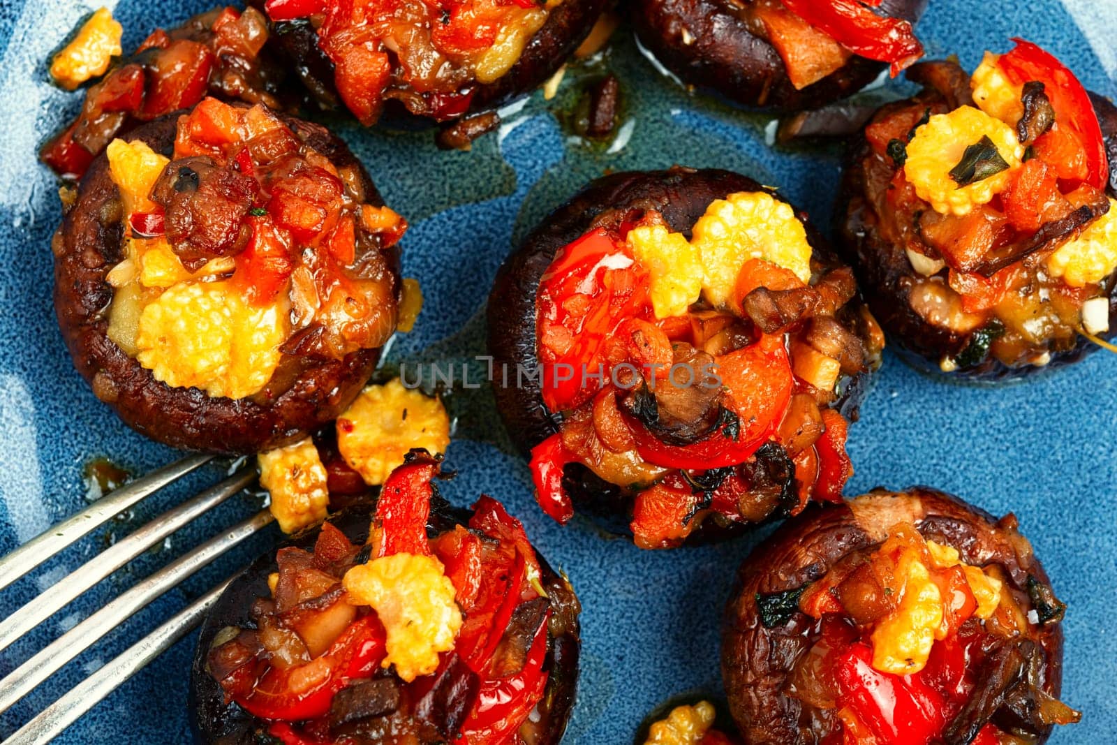 Mushroom, champignons caps baked stuffed with pepper and corn