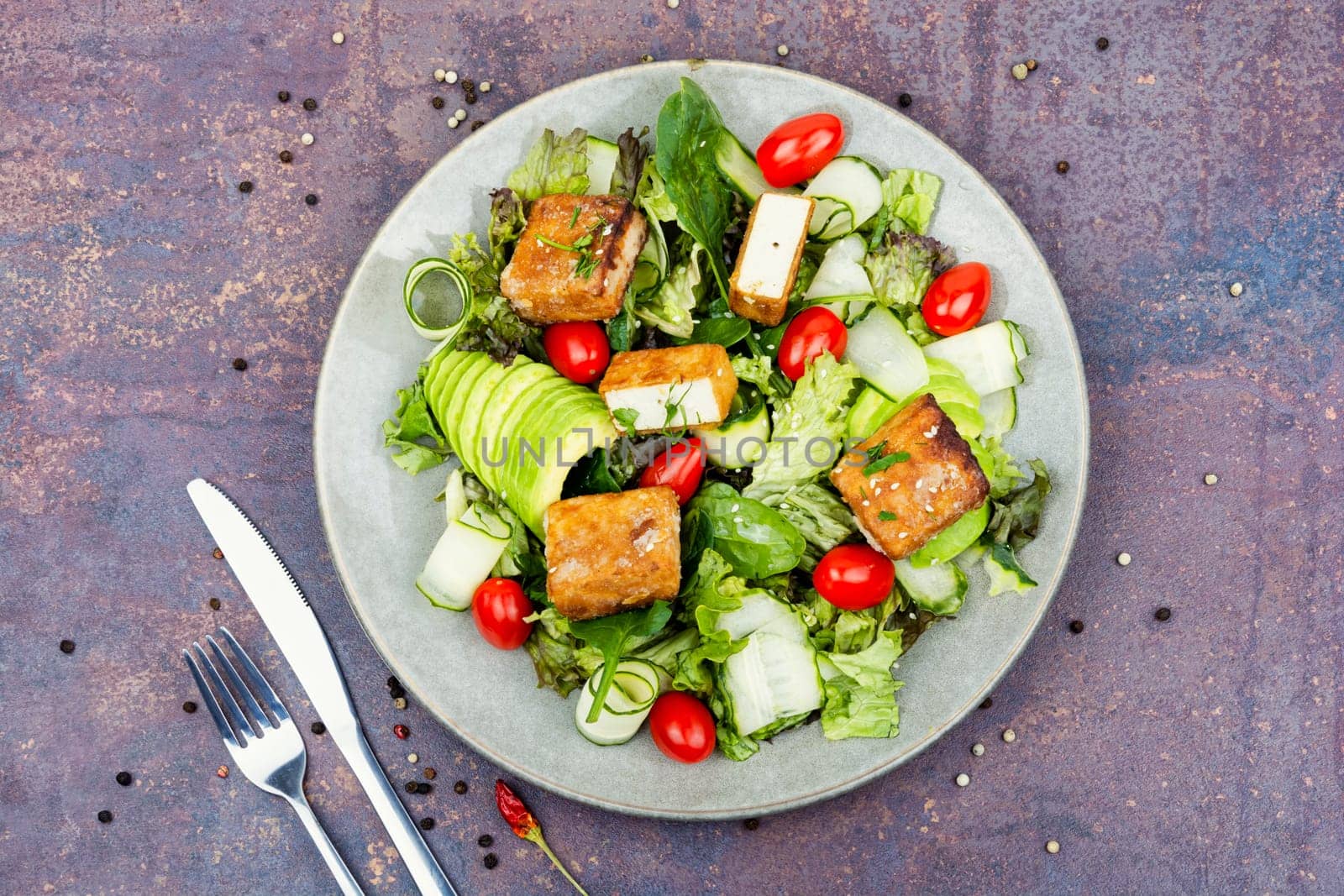 Unusual salad with fried halloumi cheese, vegetables and herbs