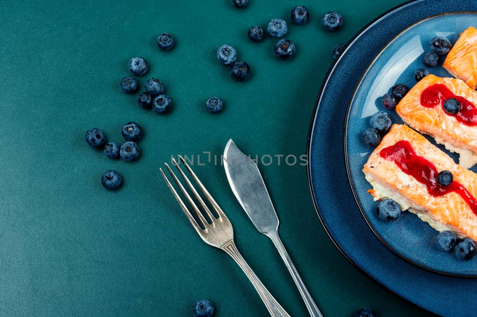Fried salmon fillet with blueberry berry sauce. Healthy food. Space for text.