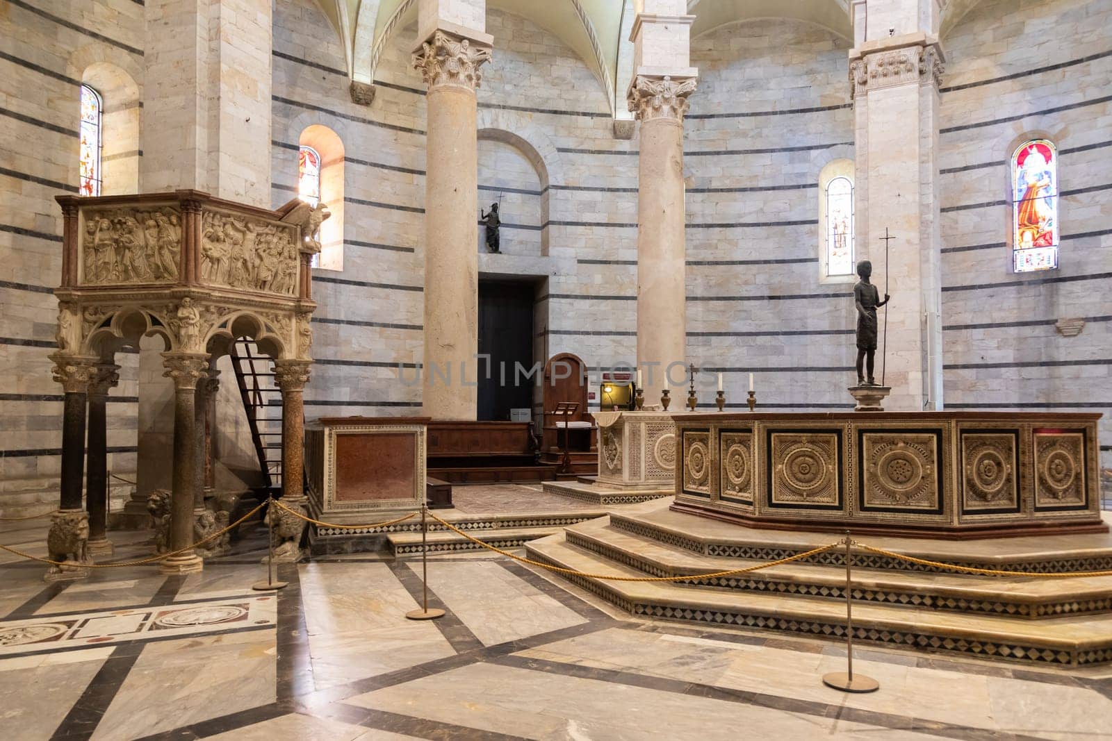 Pisa, Italy - 29 June 2023: Baptistery interior, basilica altar, catholic church. Italy travel destination.
