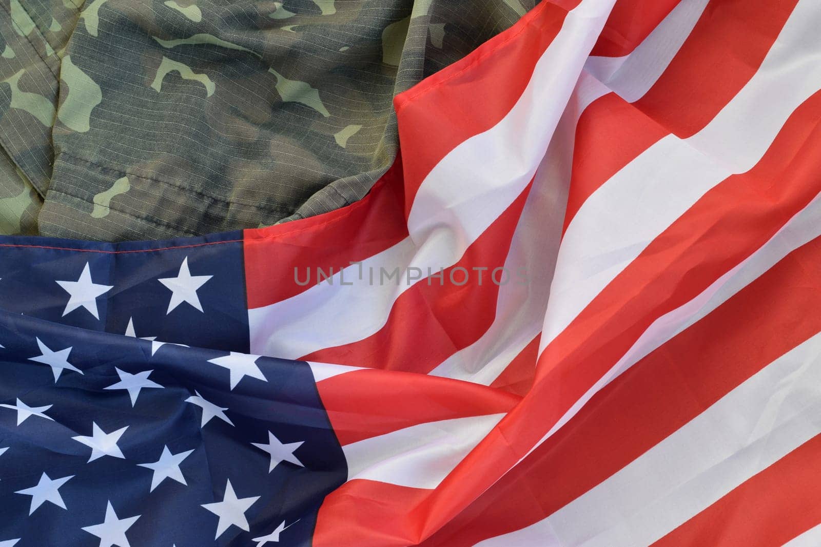 United States of America flag and folded military uniform jacket. Military symbols conceptual background banner for american patriotic holidays design