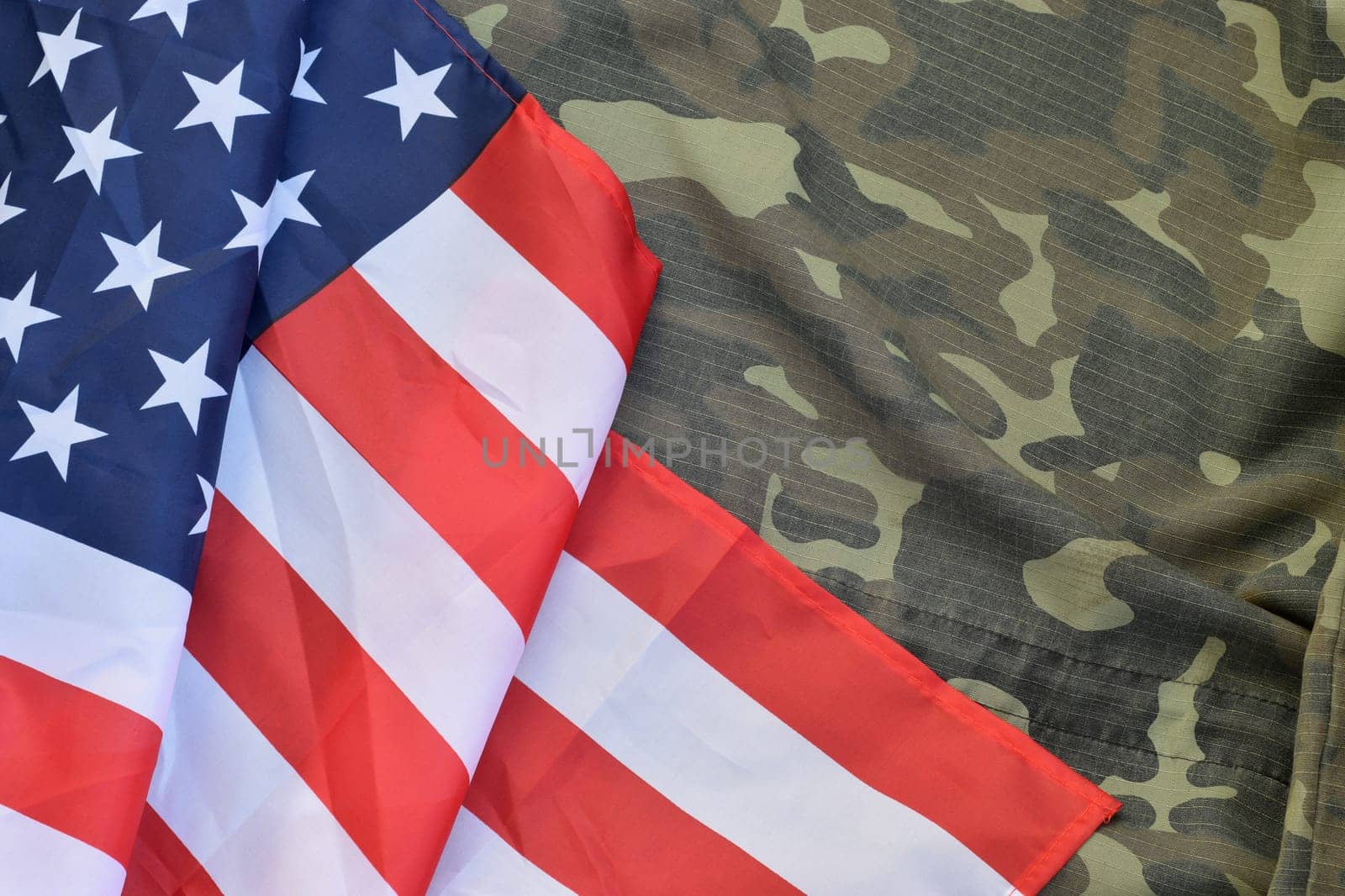 United States of America flag and folded military uniform jacket. Military symbols conceptual background banner for american patriotic holidays design