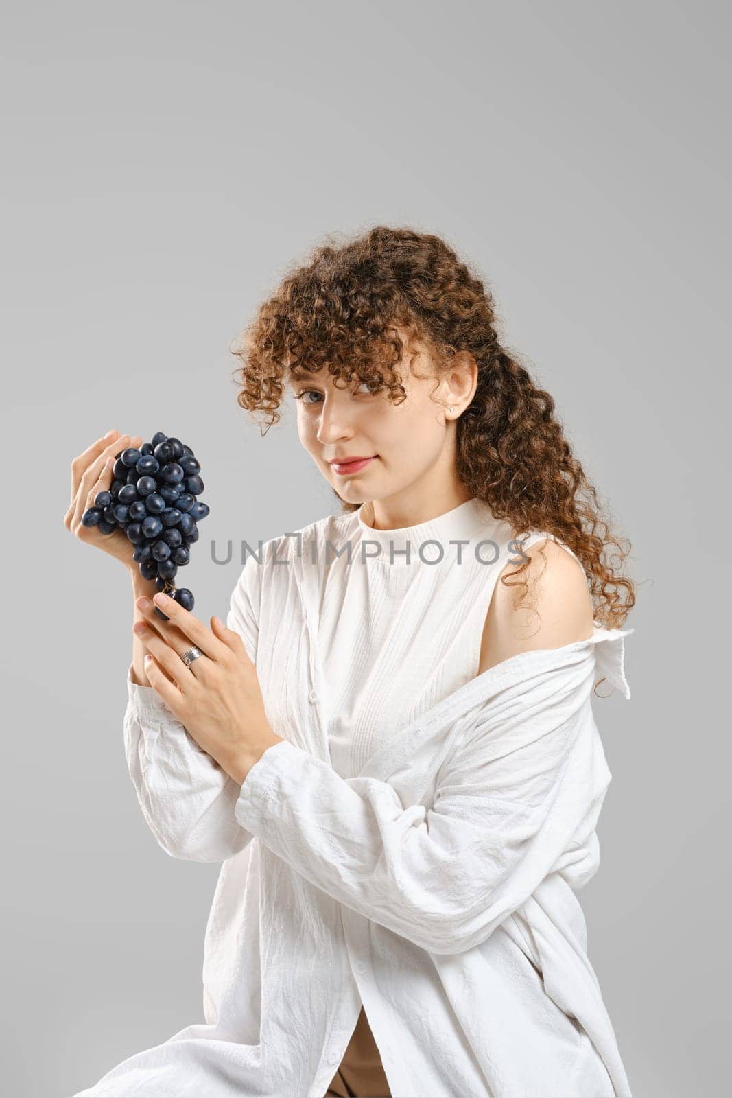 Portrait of cute woman with bunch of grape