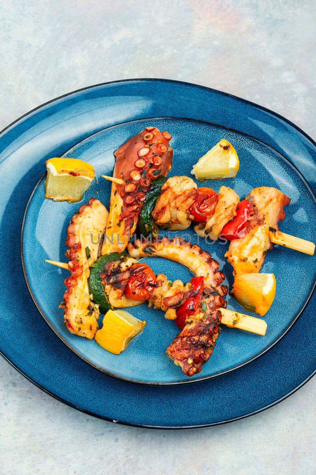 Skewers of octopus, squid and vegetables. Seafood on the skewers, pieces of suckling octopus kebab