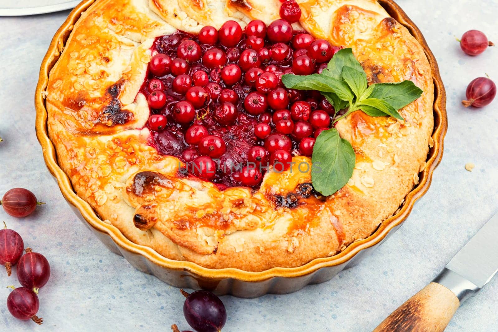 Summer pie or tart with red currants and gooseberries.