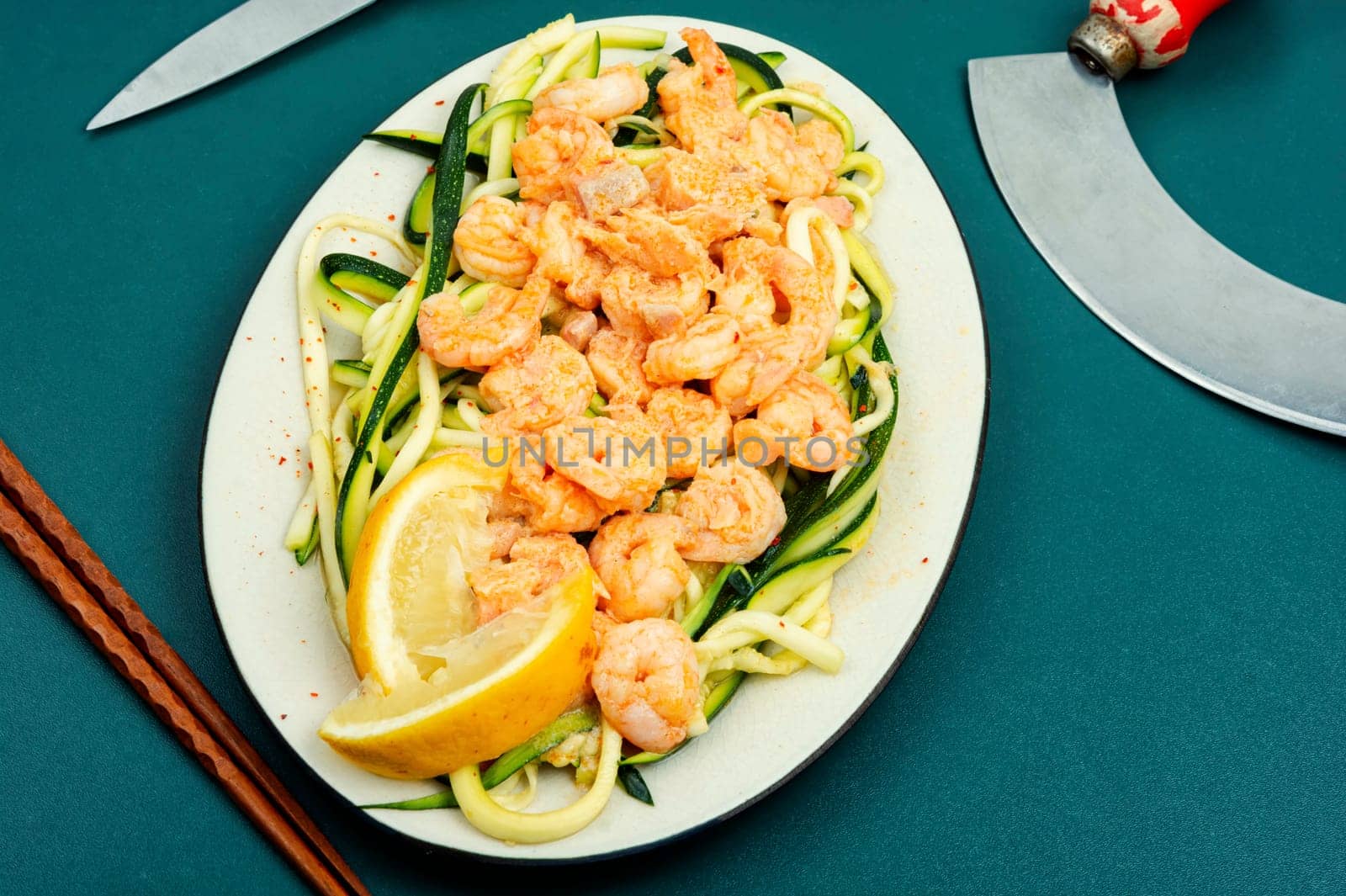 Healthy food, shrimp on a vegetable side of zucchini on white plate. Asian food.