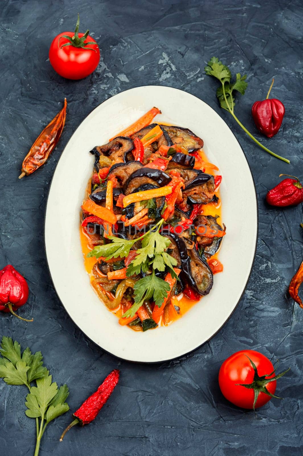 Vegetable saute with eggplant. Vegetarian food, vegetable stew. Flat lay.