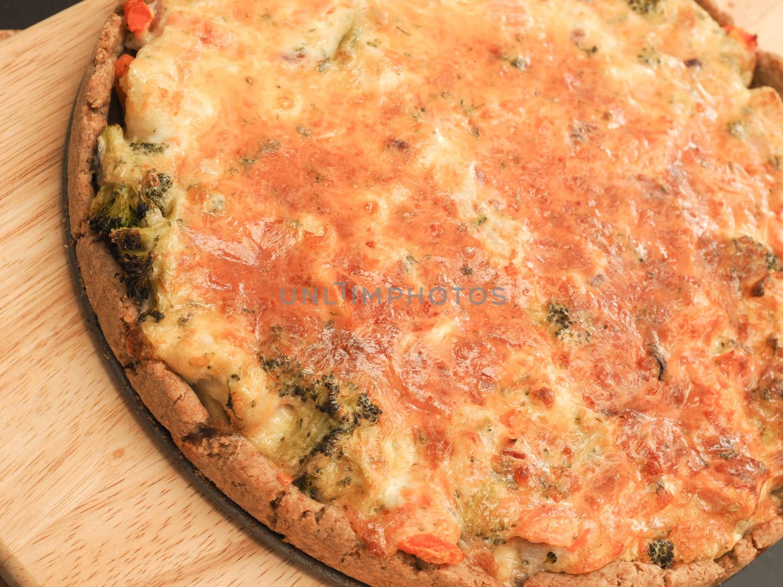 Tasty organic vegetable quiche on a cutting board in a kitchen, healthy eating or diet concept, vegetarian food