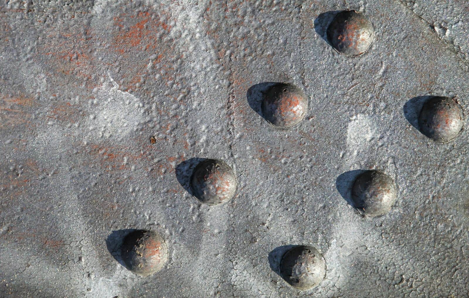 Steel rivets, rivets on an iron beam. Texture of a steel beam and rivets in arrangement.