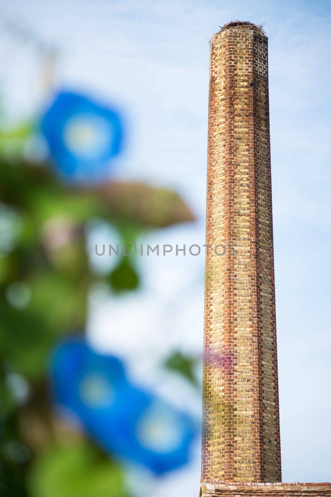 A large old industrial chimney made of red brick