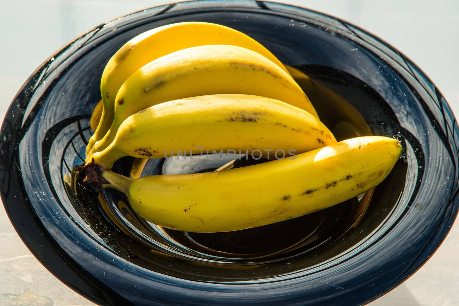 ripe bananas in a black fruit bowl