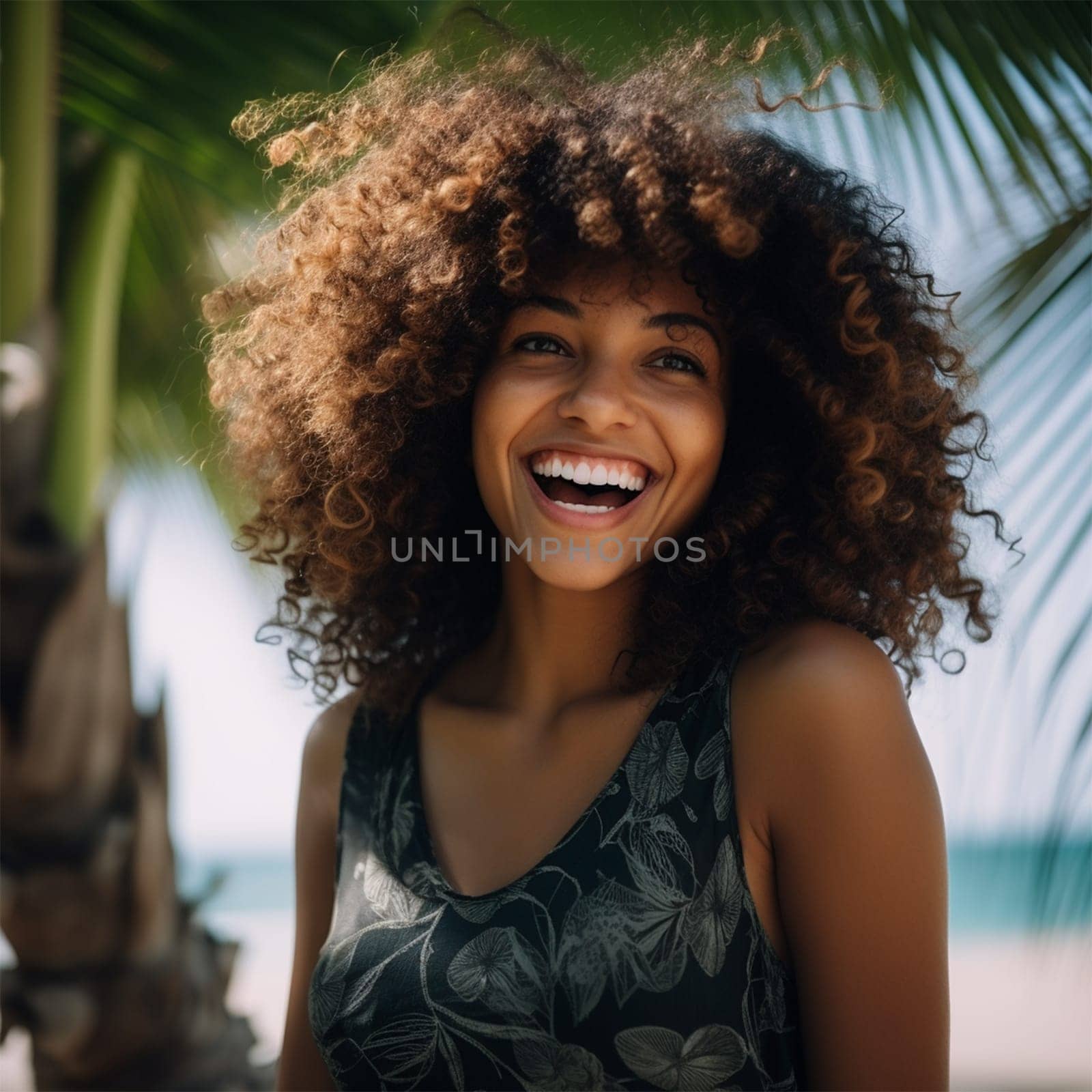 cheerful happy young woman with curly hair on a tropical island against the background of palm trees on a sunny day