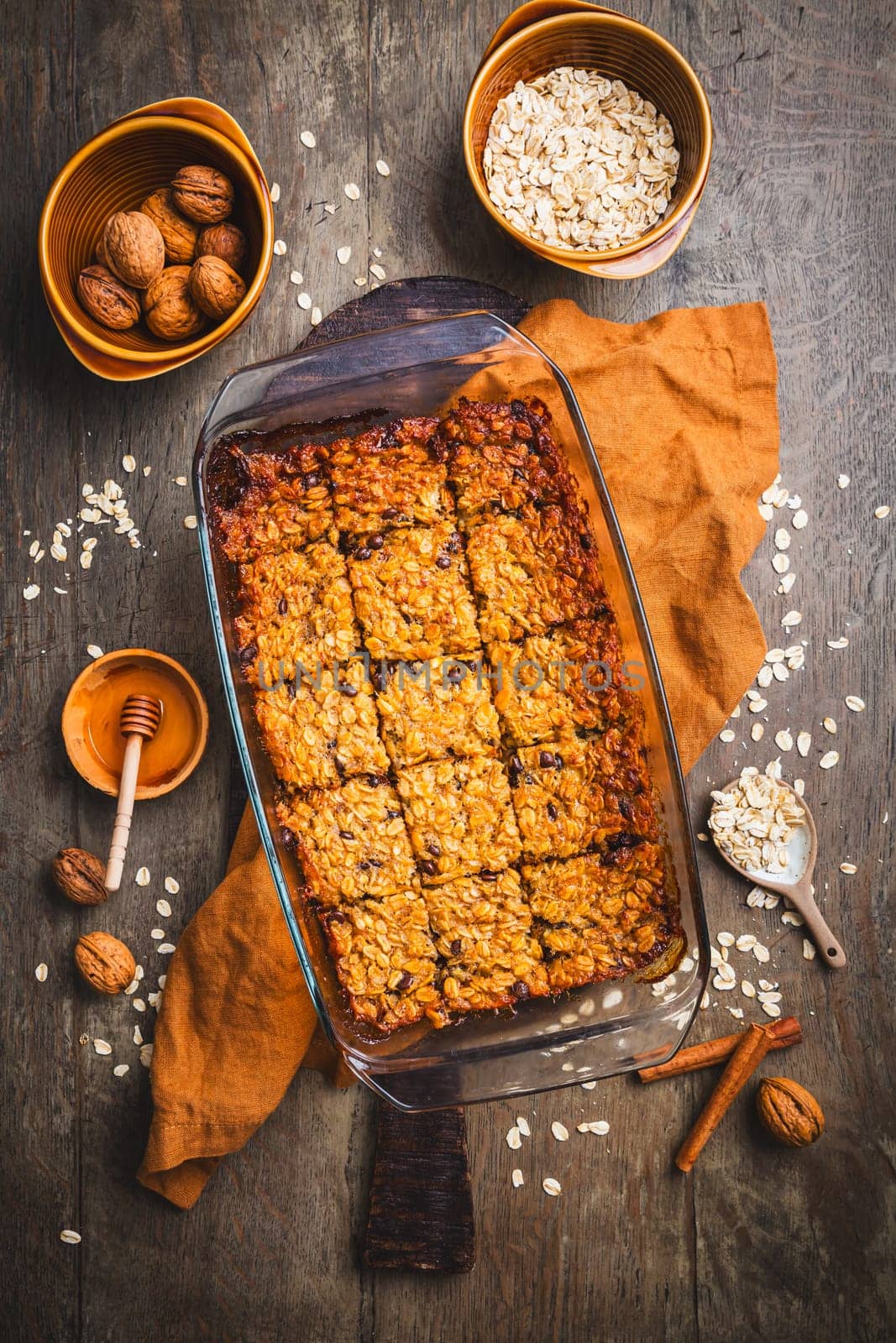 Vegan oatmeal banana bread or case with nuts on wooden kitchen table