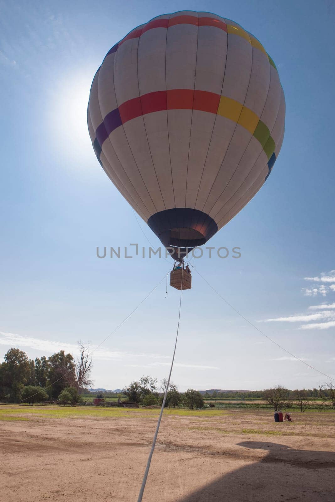 Ascending hot air balloon. Air-vehicle tethered to three fixed points