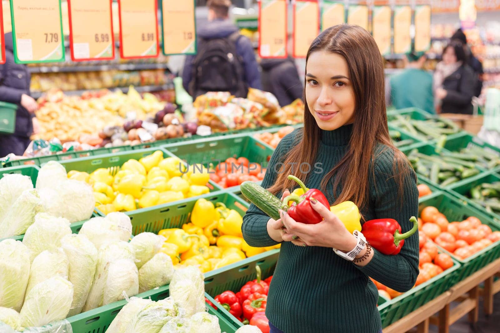 Young woman on the market with vegetables.