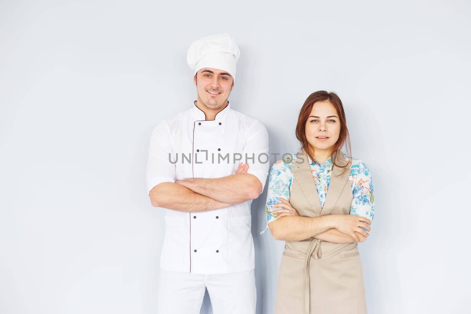 Portrait chef men with pretty young woman assistant.