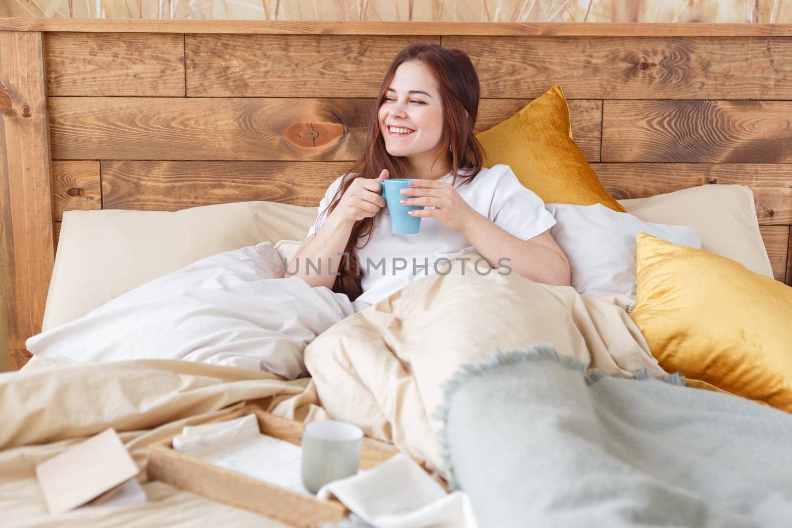 Woman drinking coffee at home or hotel.