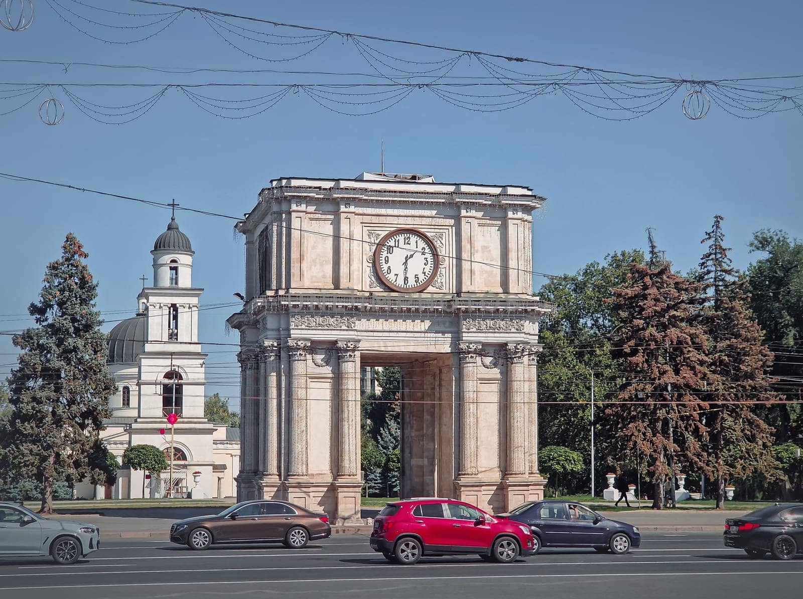 Triumphal Arch and the Metropolitan Cathedral Nativity of the Lord architectural centerpiece of Chisinau city, Moldova. Autumn season view to the landmarks from the Stephen the Great avenue