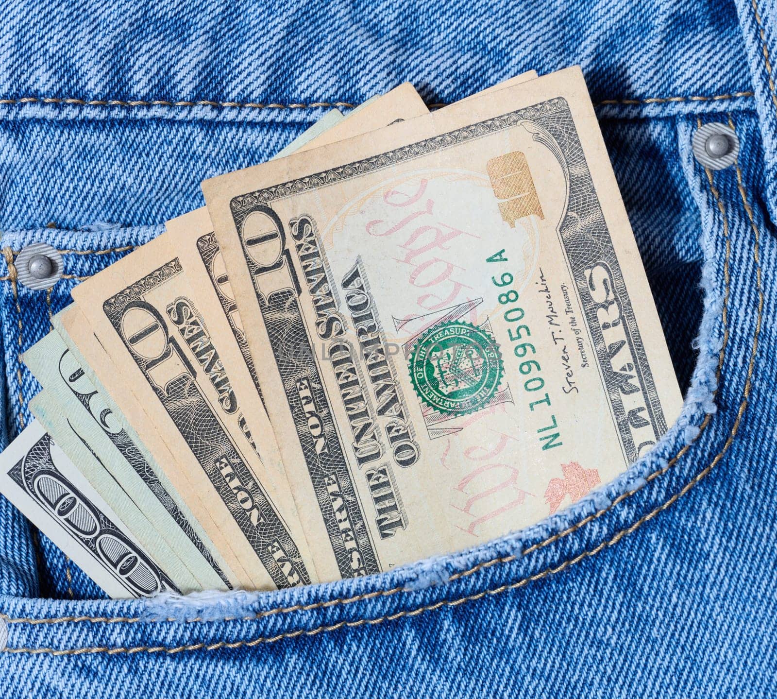 Paper American dollars in the front jeans pocket