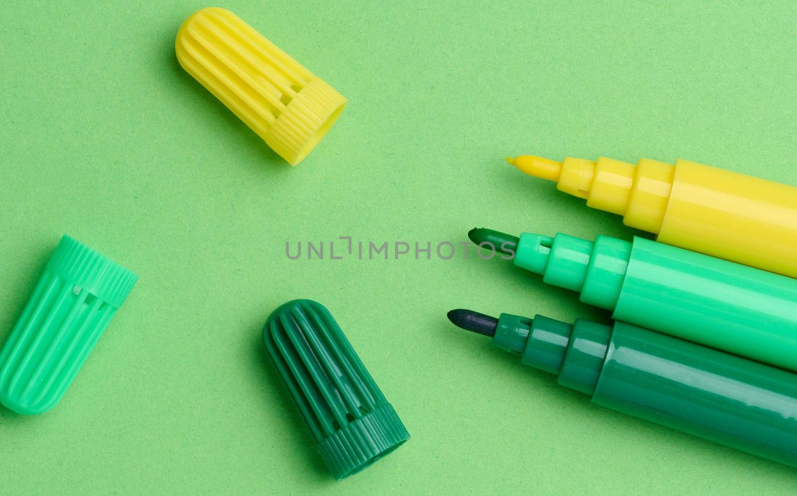 Green and yellow markers on a green background, top view