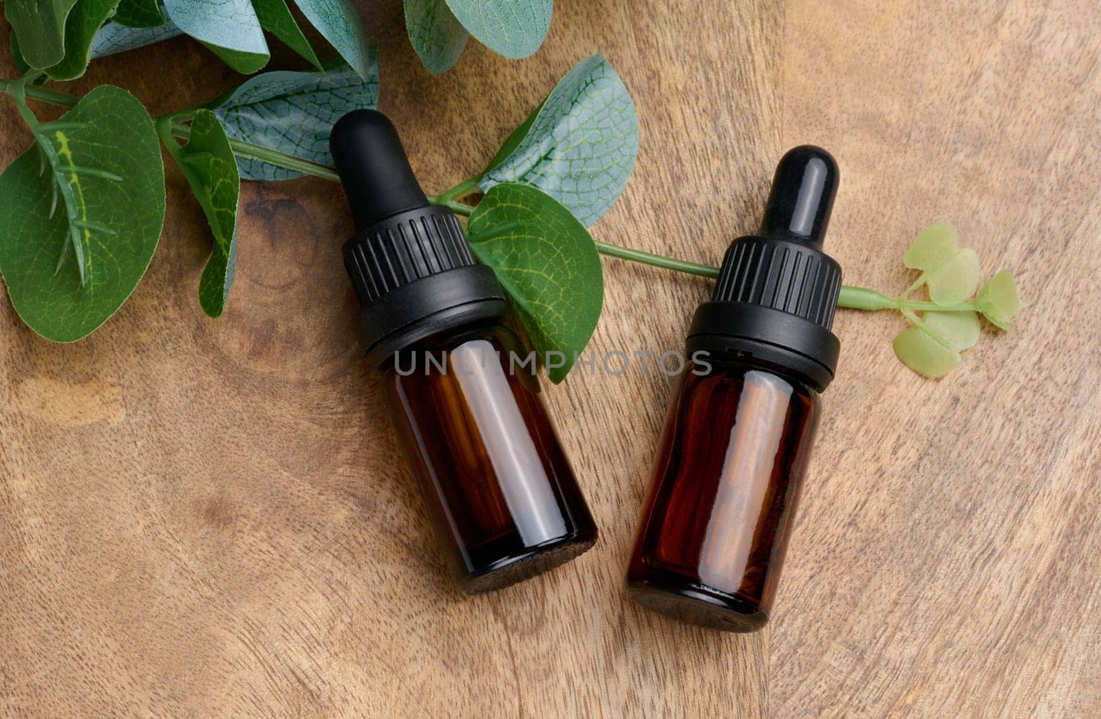 Brown glass bottle with a pipette on a beige background, a container for aromatic oils and cosmetics