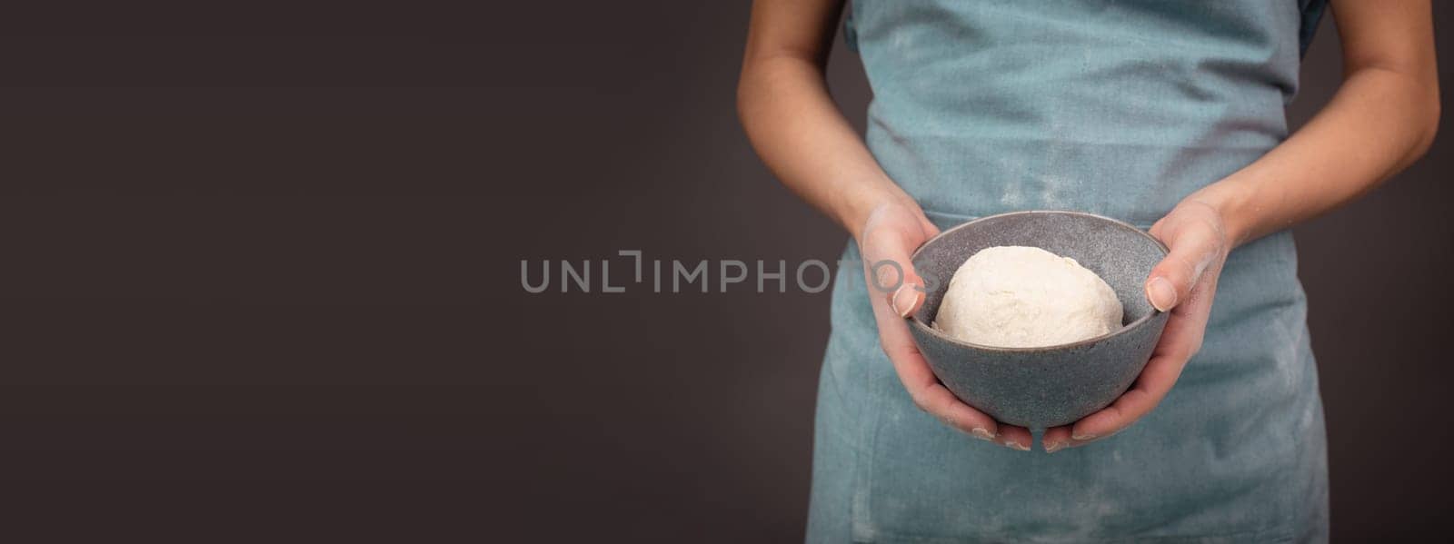 Fresh wheat dough, baker holds bowl with flour, bread or pizza, prepare ingredients for food, baking pastry