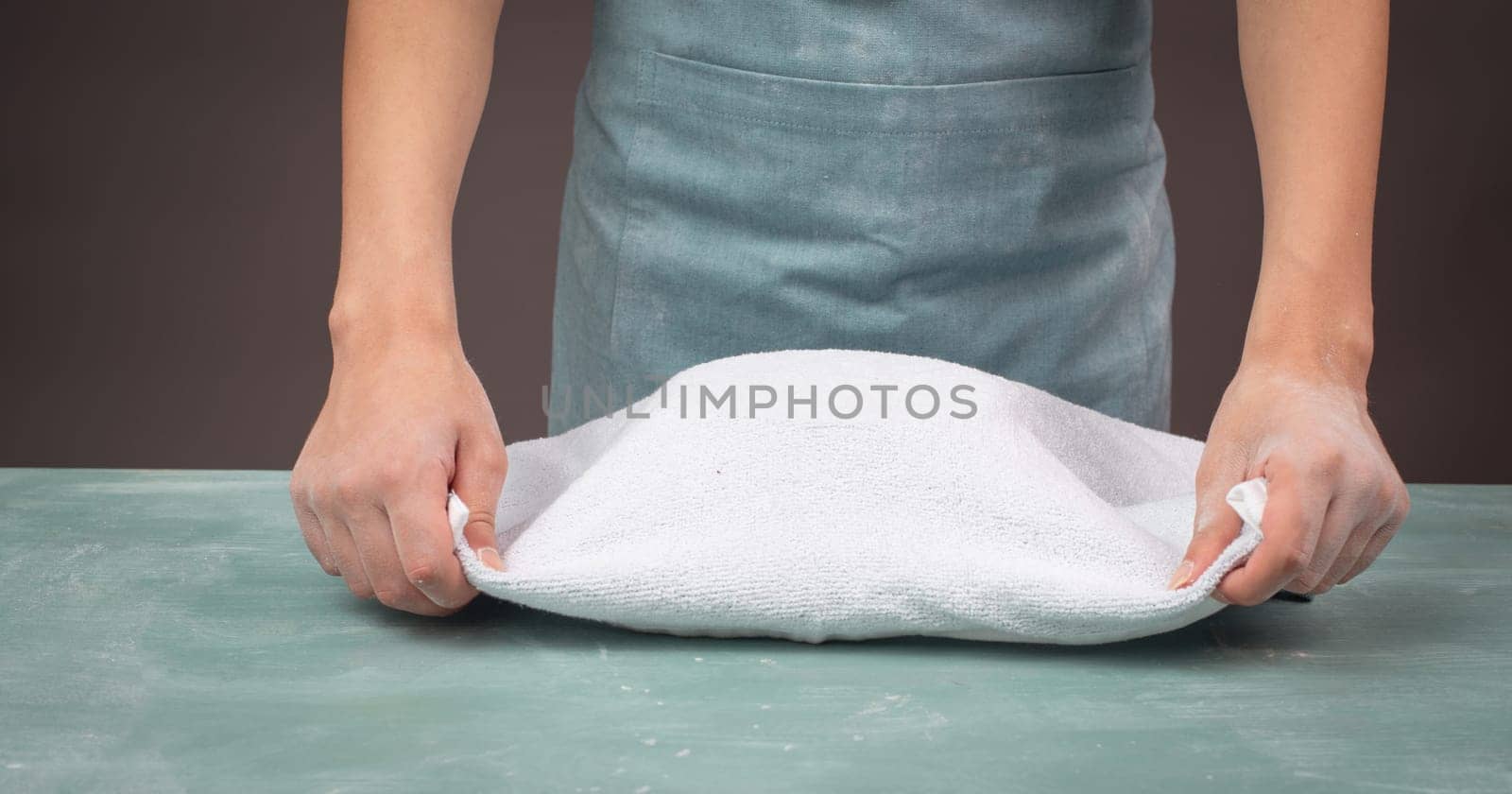 Fresh yeast dough, baker covers bowl with towel for fermentation, bread or pizza, prepare ingredients for food, baking pastry