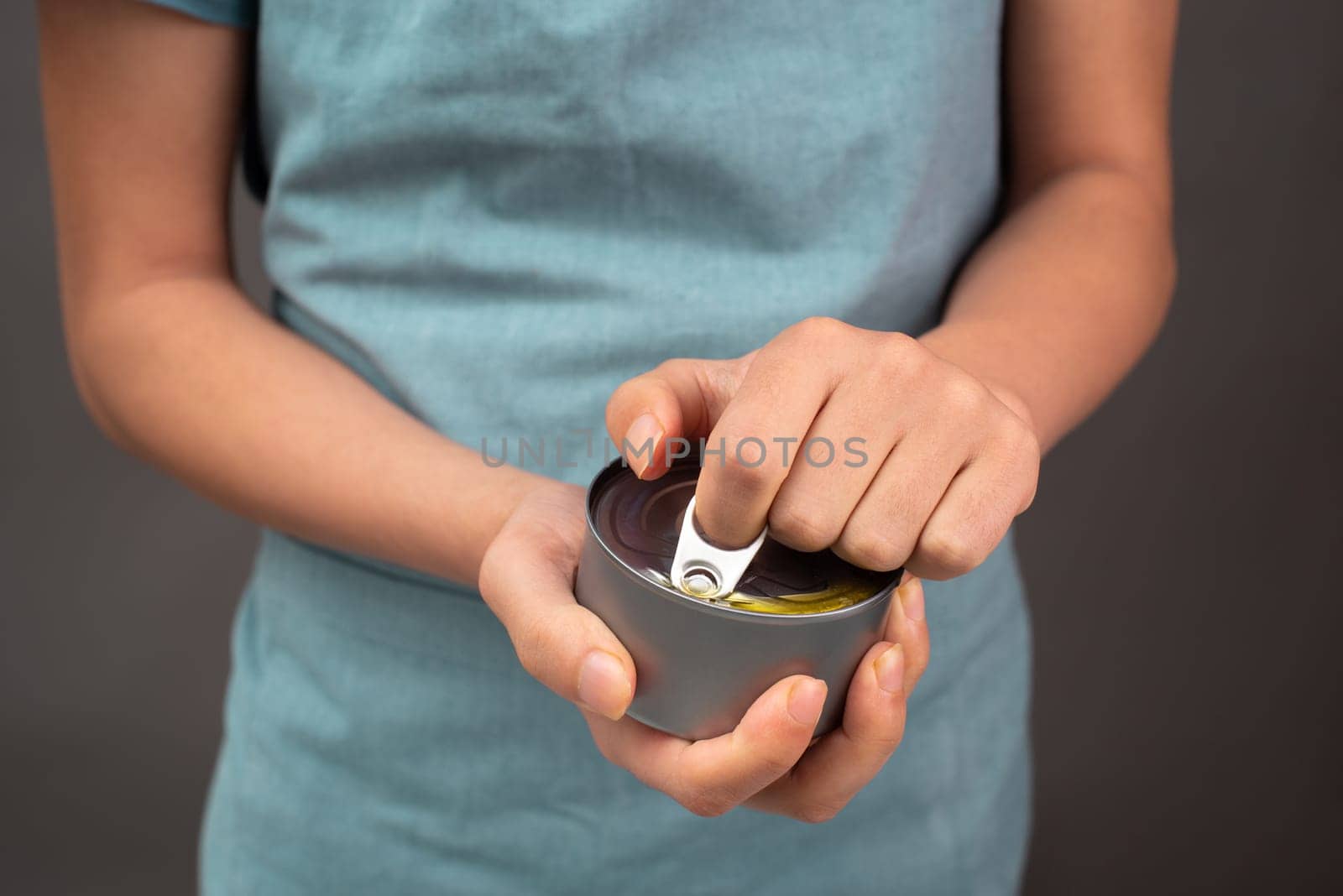 Opening a tin can with preserved food, box with tuna fish, processed ingredients, feeding a pet