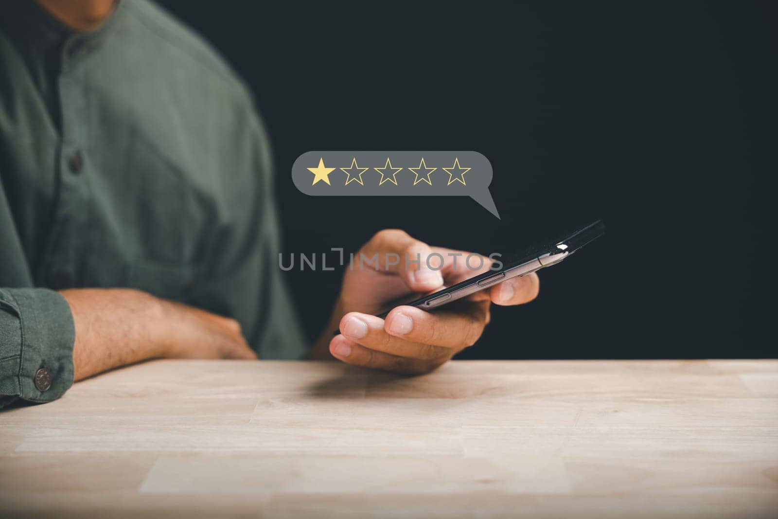 Unhappy client uses smartphone to give a 1-star satisfaction rating on social media. Negative feedback concept impacting business reputation and customer perception.