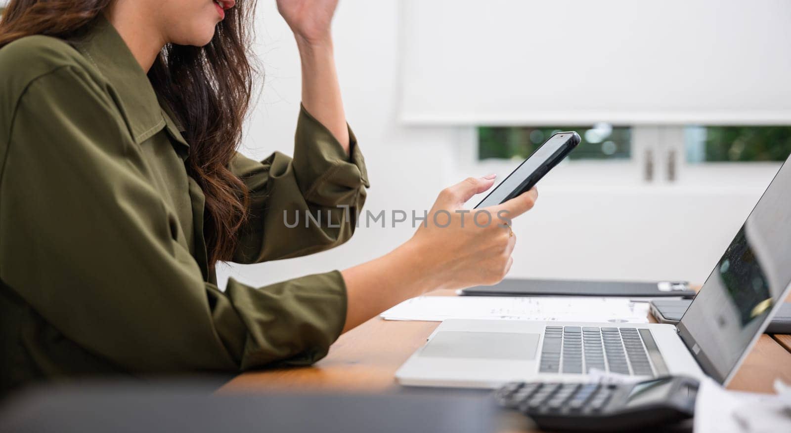 Asian young woman pay for goods digital payment success on smartphone, Smile female buy product on laptop computer she pay money by mobile phone, Easy E-commerce shopping online, lifestyles technology