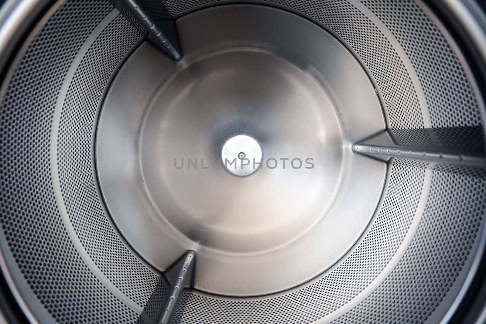 Close up Inside of washing machine tub with opened door is made of stainless steel, brand new drum material metal electrical household appliance, Empty inside