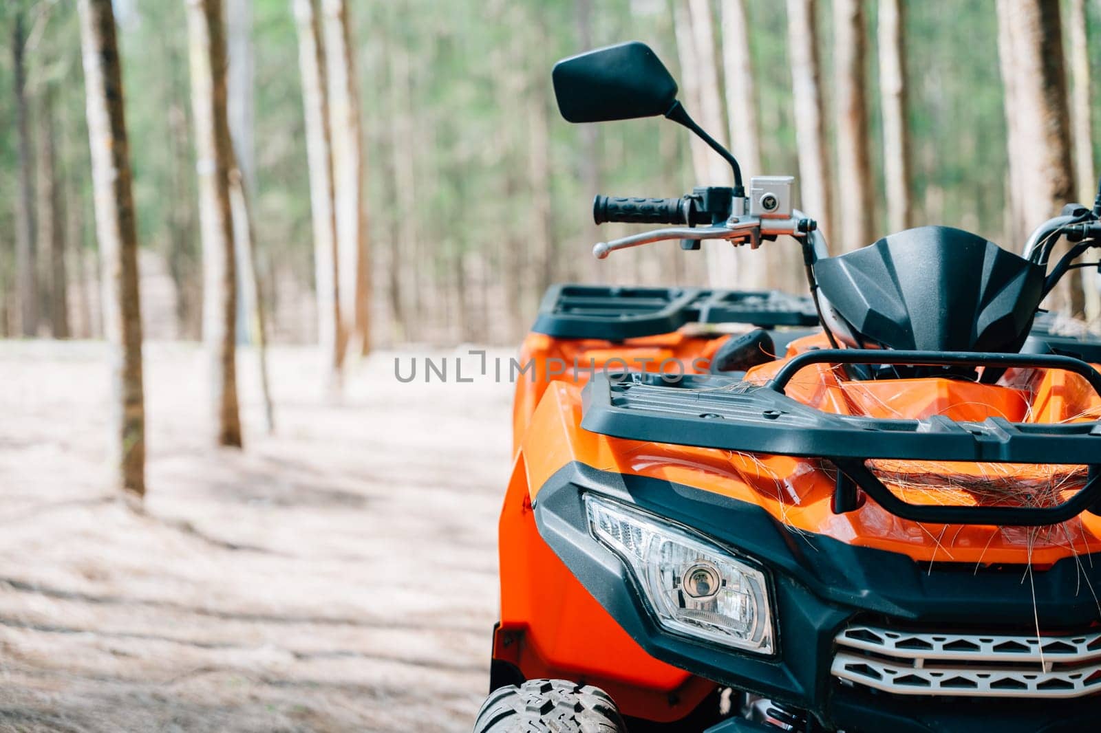 A quadbike competition in the autumn field, with the sun rising and the wheels kicking up mud and dirt, closeup Extreme recreation activity concept
