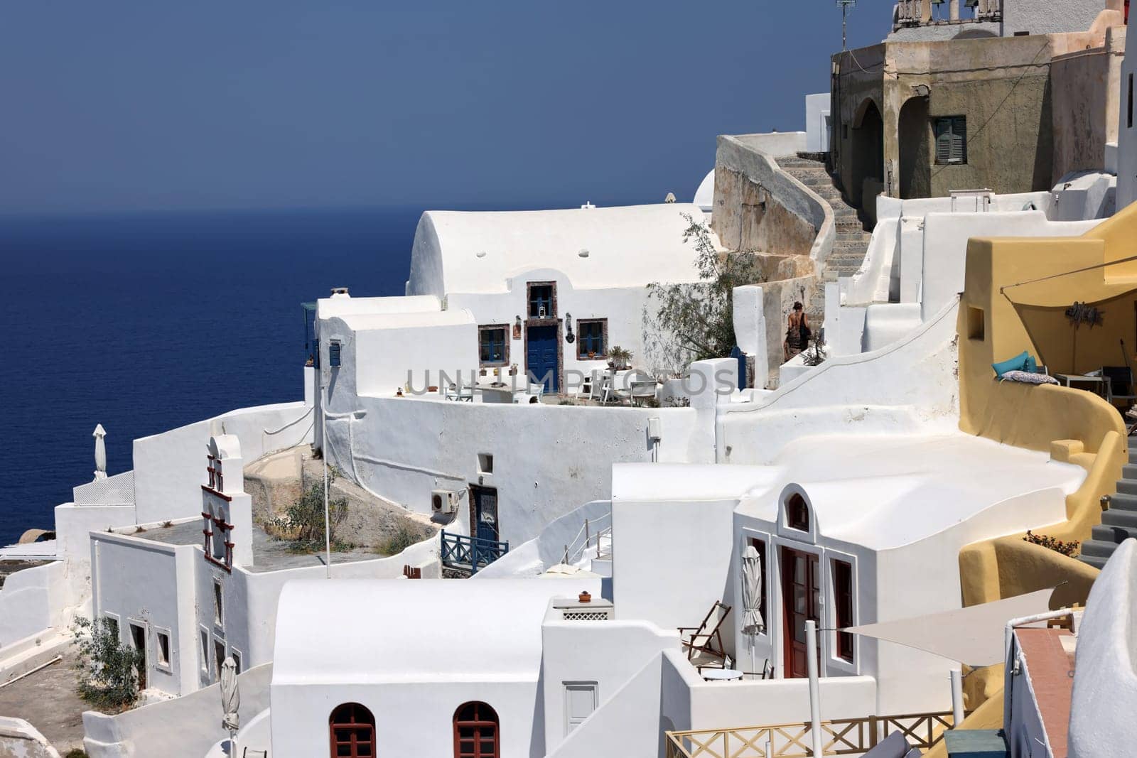 Whitewashed houses with terraces and a beautiful view in Oia on Santorini island, Greece