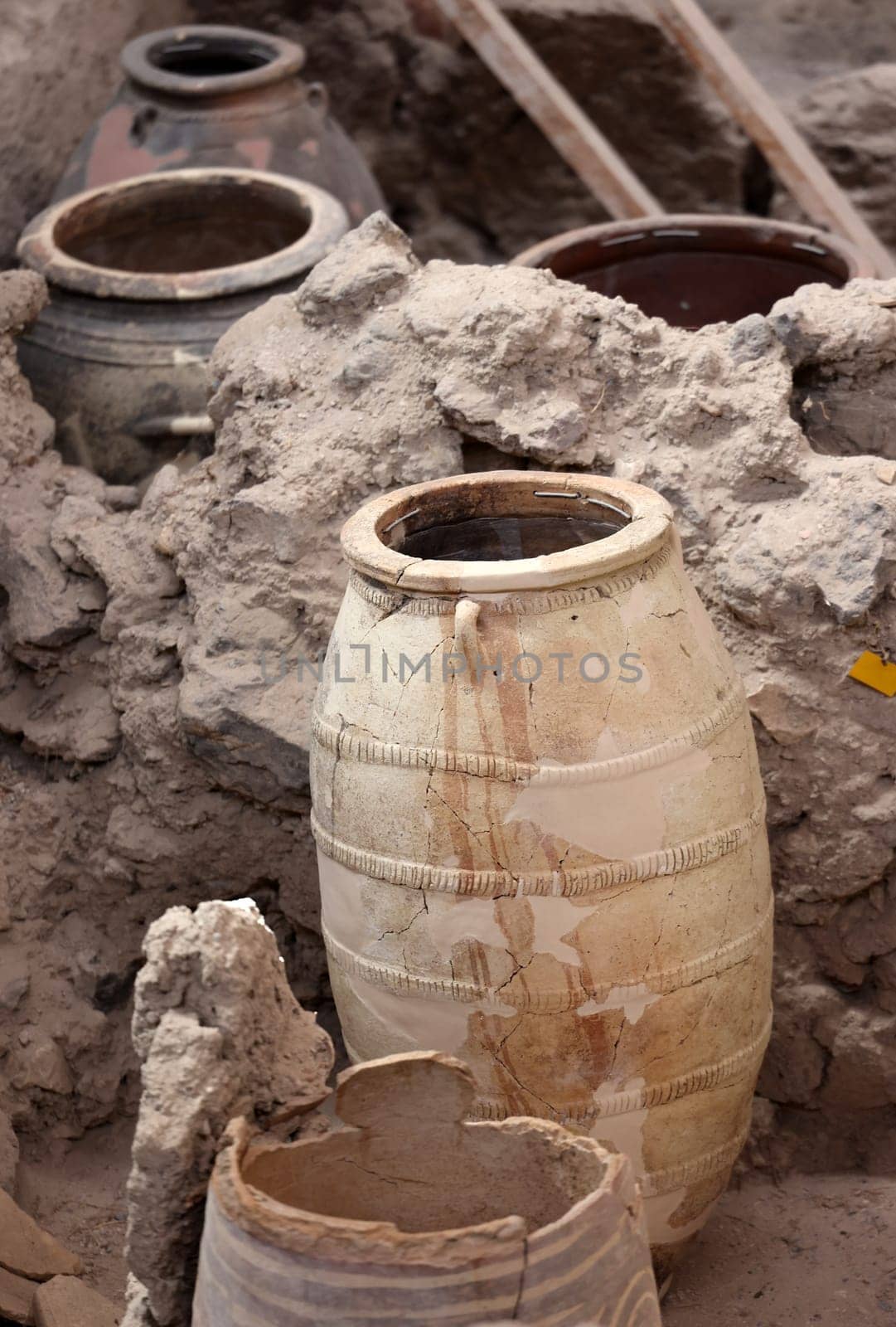 Santorini, Greece - July 01, 2021: Recovered ancient pottery in prehistoric town of Akrotiri, excavation site of a Minoan Bronze Age settlement on the Greek island of Santorini