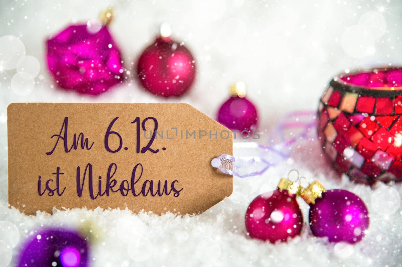 Label With German Text Am 6.12. Ist Nikolaus, Means Saint Nikolaus on December 6th in English, Purple Christmas Decoration, Snow And Winter Background