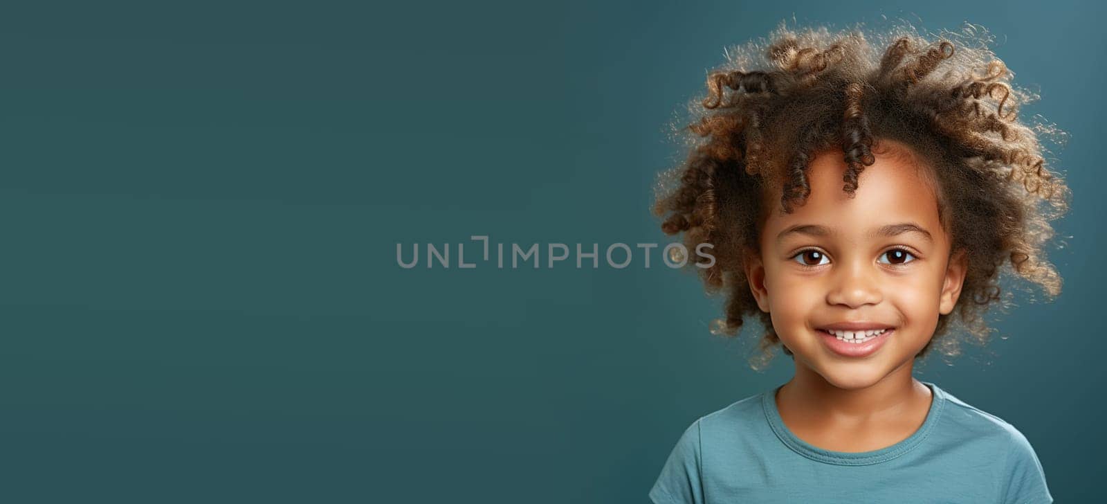 Portrait of a happy black african girl, smiling child face, childhood concept, positive emotion, blue background