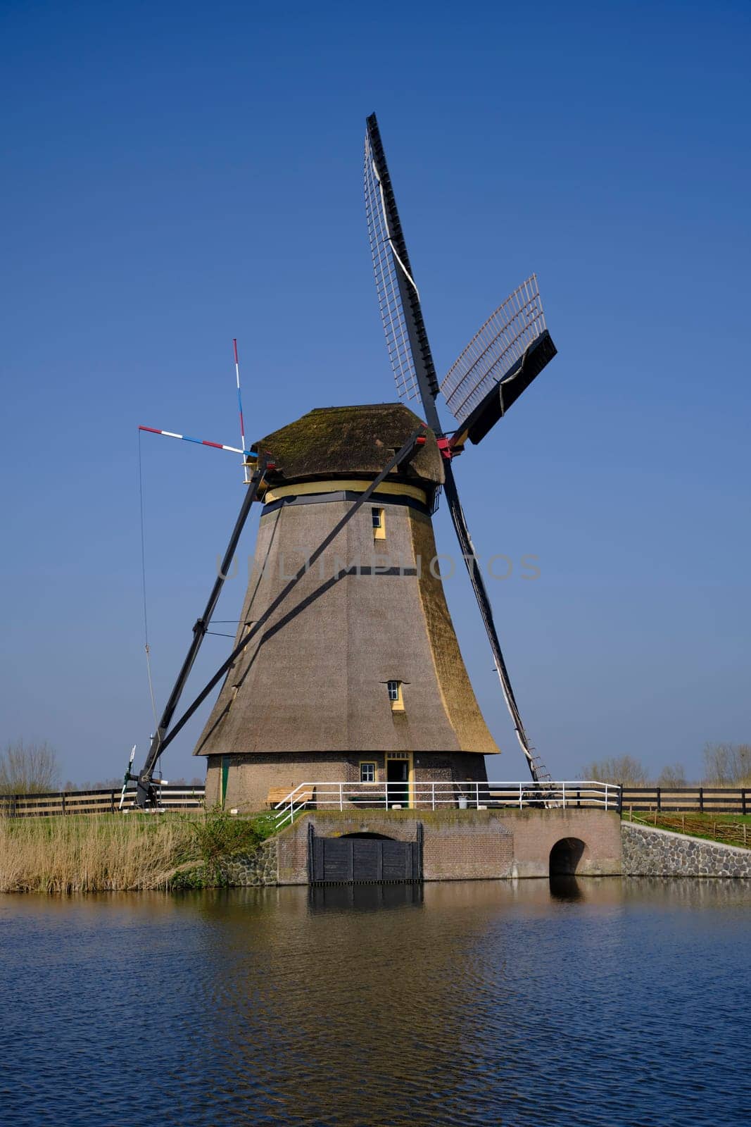 Traveling In The Netherlands. View of Traditional Romantic Dutch Windmills in Kinderdijk Village in the Netherlands Before Sunset. Horizontal Shot