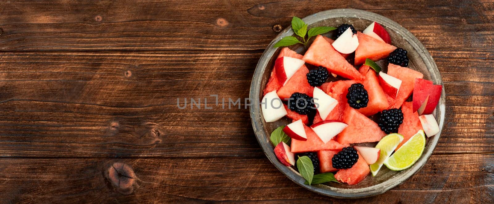 Vitamin salad of watermelon, blackberry and peach. Healthy summer dessert