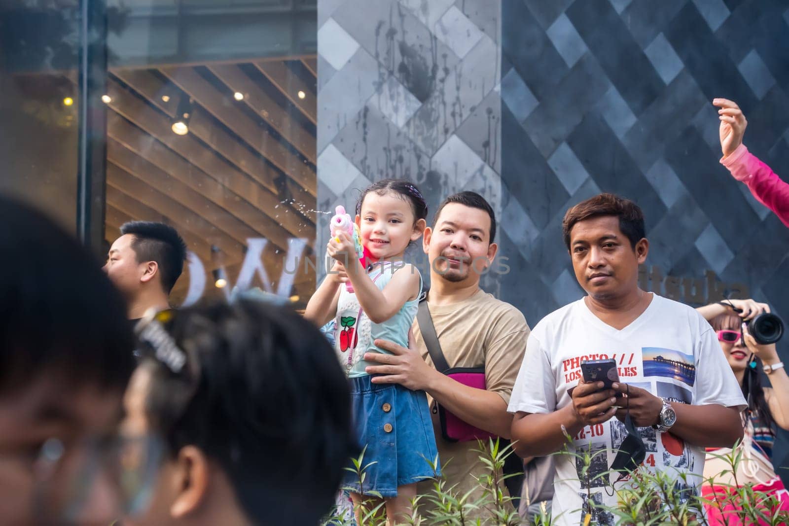 Siam Square, Bangkok, Thailand - APR 14, 2023 Songkran Festival, The short action of people joins celebrations of the Thai New Year or Songkran in Siam Square Bangkok, Thailand.