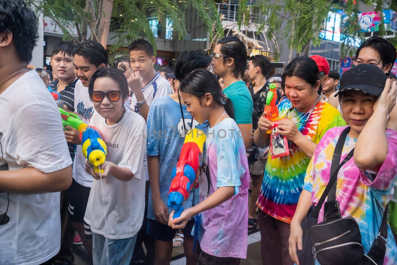 Siam Square, Bangkok, Thailand - APR 14, 2023 Songkran Festival, The short action of people joins celebrations of the Thai New Year or Songkran in Siam Square Bangkok, Thailand.