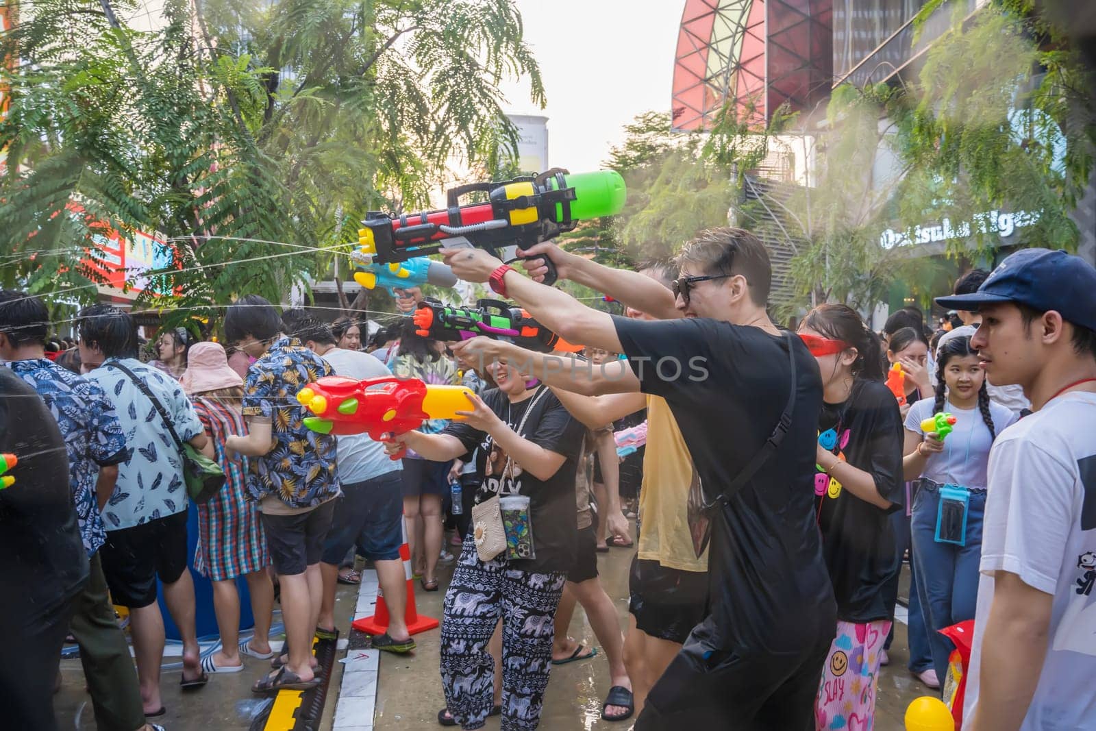Siam Square, Bangkok, Thailand - APR 14, 2023 Songkran Festival, The short action of people joins celebrations of the Thai New Year or Songkran in Siam Square Bangkok, Thailand.