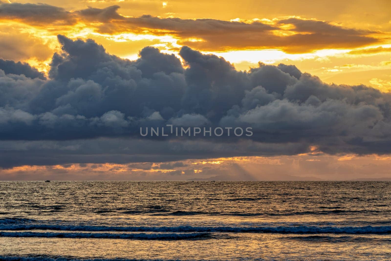 Evening view of the Pacific Coast of Tarcoles in Carara with sunset and glittering waves . romantic sunset landscape. Tarcoles, Costa Rica. Pura Vida concept, travel to exotic tropical country.