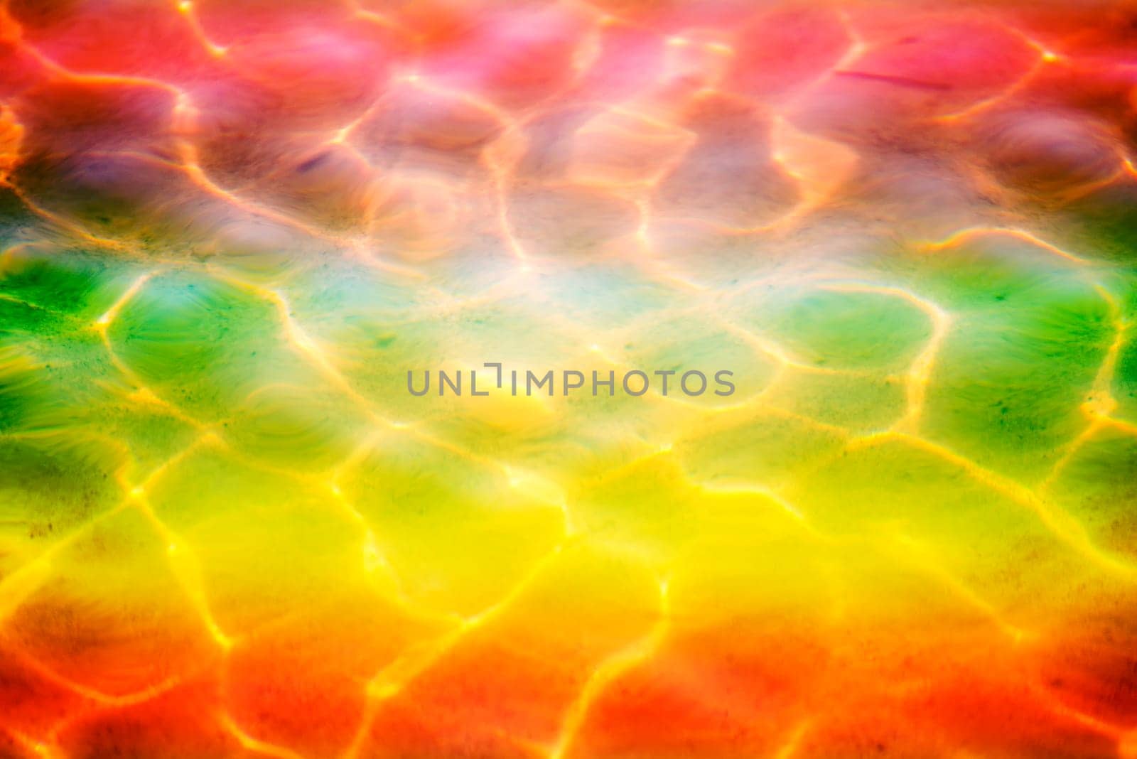 Water of the sea with sun reflections in LGBTQ colors